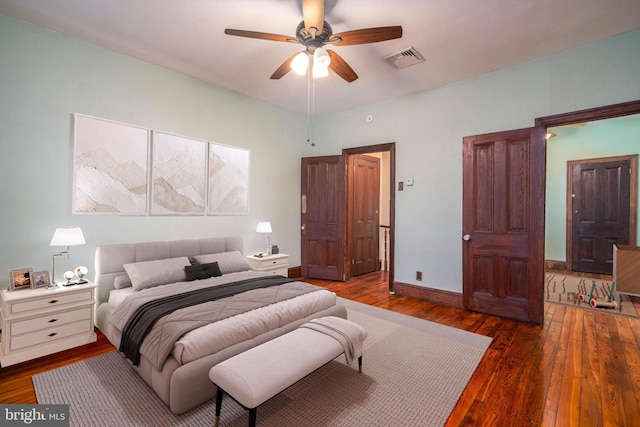 bedroom with ceiling fan and dark hardwood / wood-style flooring