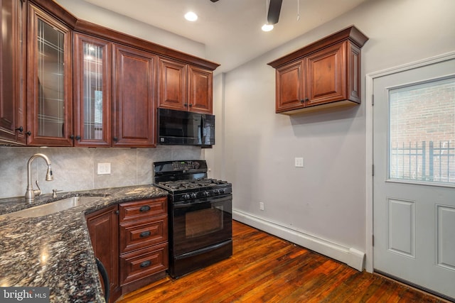 kitchen with black appliances, sink, ceiling fan, and dark hardwood / wood-style floors