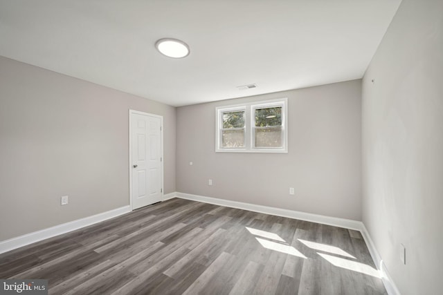 unfurnished room with dark hardwood / wood-style floors