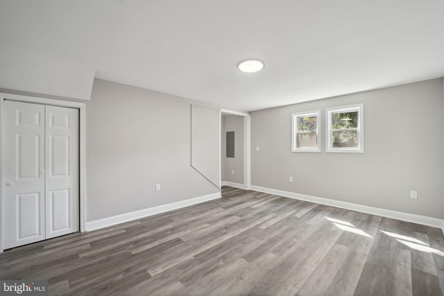 unfurnished bedroom with a closet and hardwood / wood-style floors