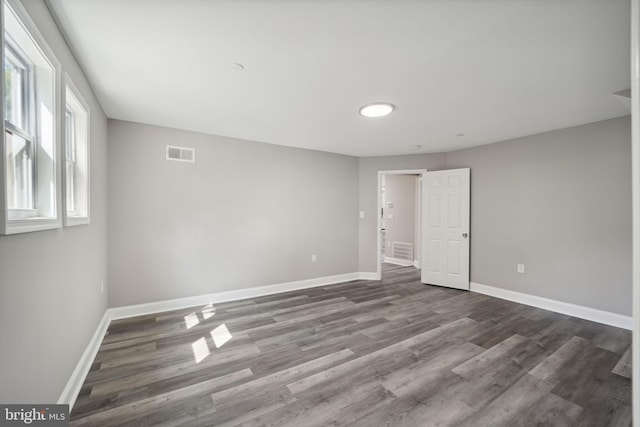 unfurnished room featuring dark wood-type flooring