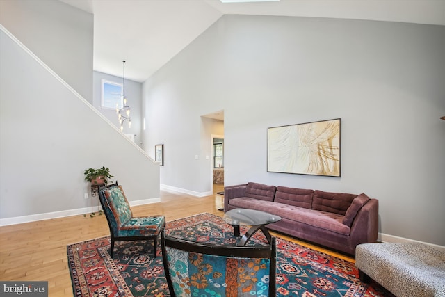 living room with high vaulted ceiling and wood-type flooring