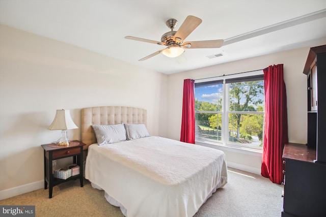 bedroom with ceiling fan and light colored carpet