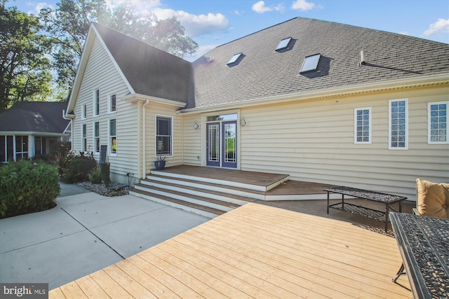 exterior space with french doors, a wooden deck, and a patio area