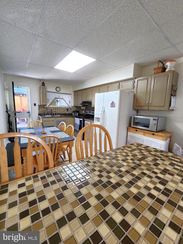 dining area featuring a drop ceiling