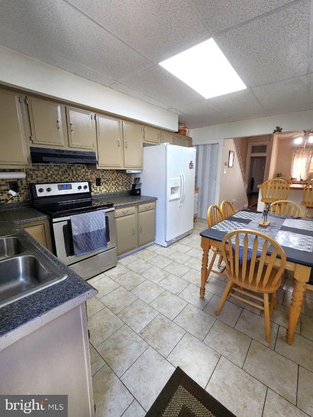 kitchen featuring white fridge with ice dispenser, electric range, a paneled ceiling, decorative backsplash, and light tile patterned floors