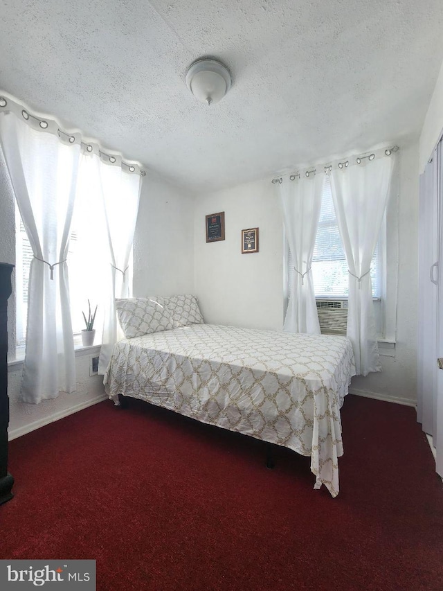 carpeted bedroom featuring a textured ceiling