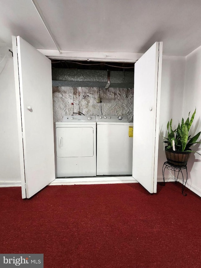 laundry room with separate washer and dryer and carpet