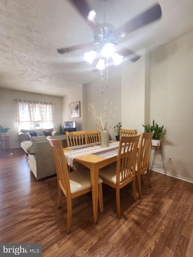 dining area with a textured ceiling, dark hardwood / wood-style flooring, and ceiling fan