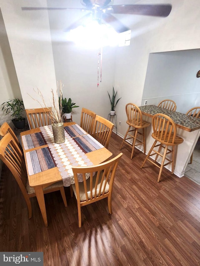 dining space featuring ceiling fan and dark hardwood / wood-style flooring