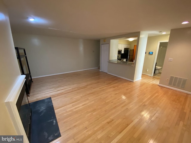 unfurnished living room featuring light wood-type flooring