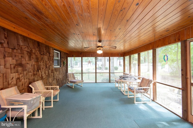 unfurnished sunroom featuring ceiling fan and wooden ceiling