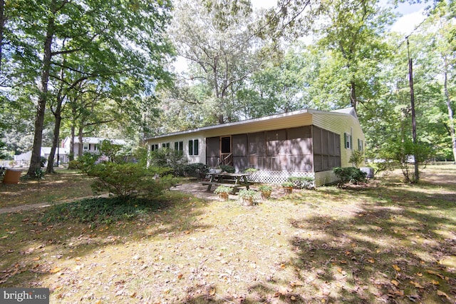 back of property with a sunroom