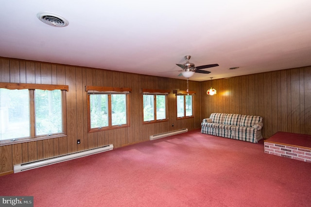 carpeted spare room with a baseboard radiator, a wealth of natural light, and ceiling fan