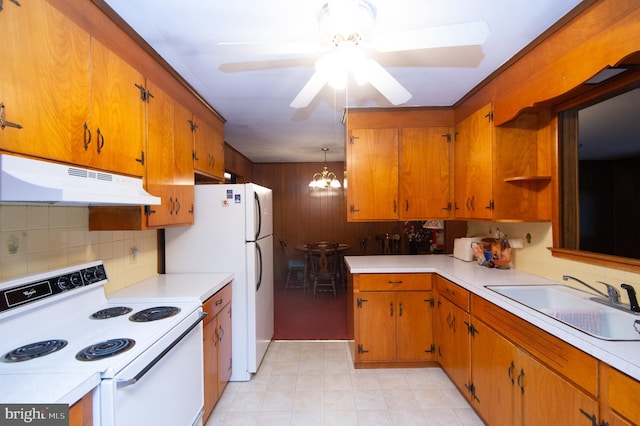 kitchen with ceiling fan with notable chandelier, white appliances, sink, and decorative backsplash