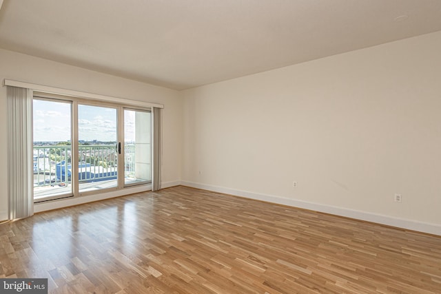 spare room with light hardwood / wood-style flooring