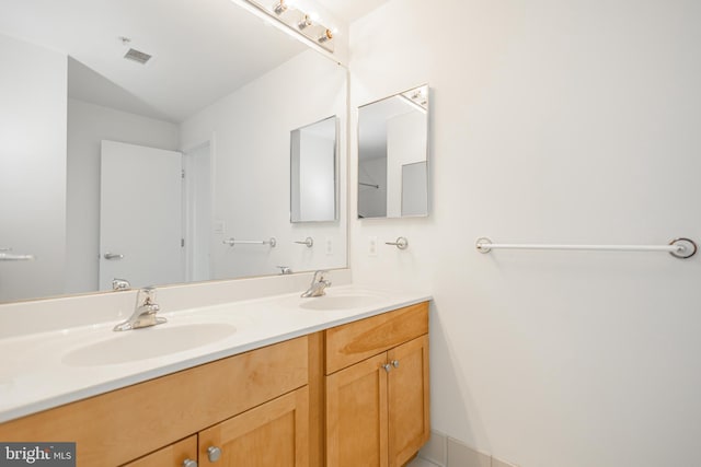 bathroom featuring a sink, visible vents, and double vanity