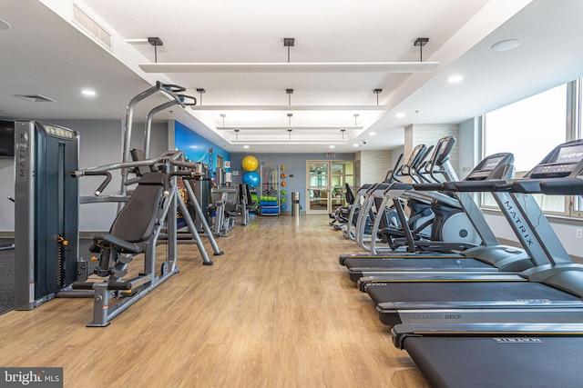 workout area featuring visible vents, recessed lighting, and wood finished floors