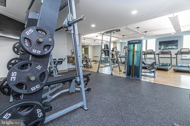 workout area with hardwood / wood-style floors