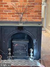 room details with a wood stove and a fireplace