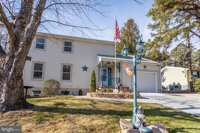 front facade featuring a garage and a front yard