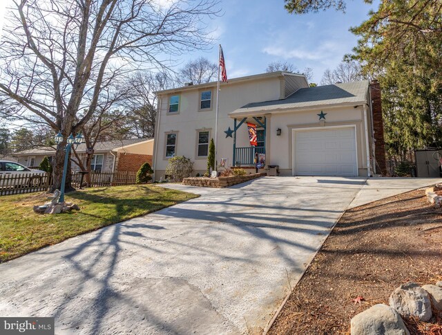 view of front of property featuring a garage and a front yard