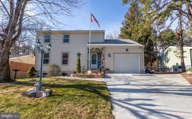 view of front of house with a front yard and a garage