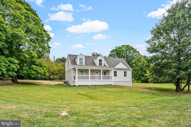 view of front of home with a front lawn and central air condition unit