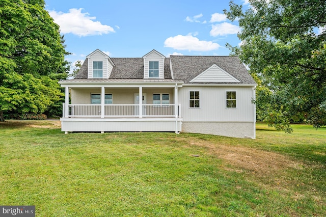 rear view of house featuring a yard