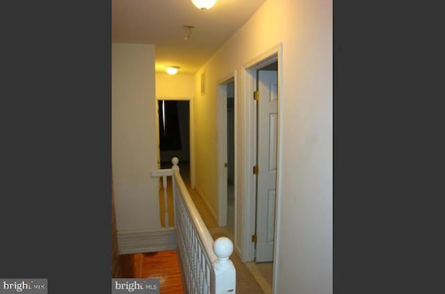 hallway with hardwood / wood-style floors