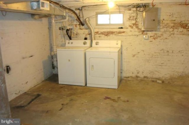 basement with separate washer and dryer and electric panel