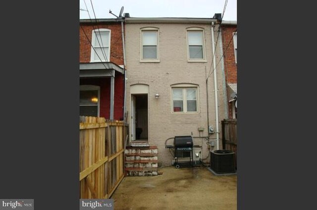 back of house featuring cooling unit