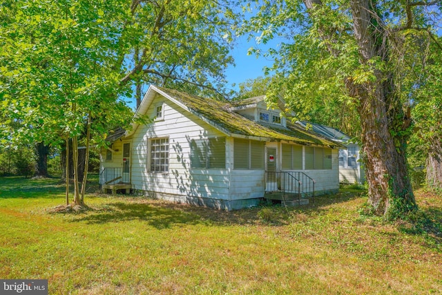 view of home's exterior with a yard