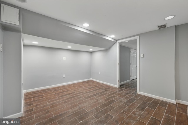 basement featuring dark hardwood / wood-style flooring