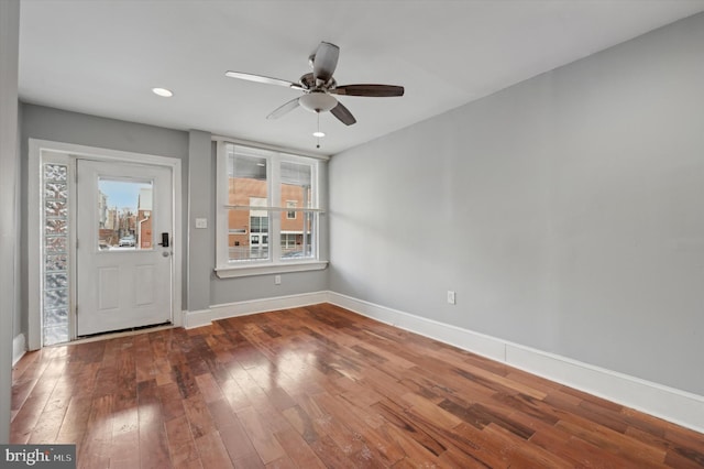 interior space with ceiling fan and wood-type flooring