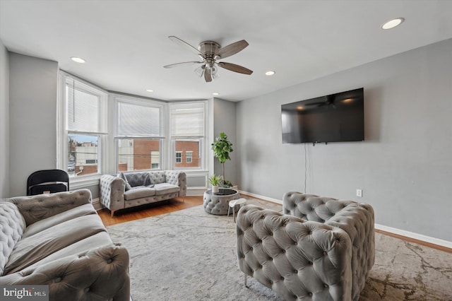 living room featuring ceiling fan and light hardwood / wood-style floors