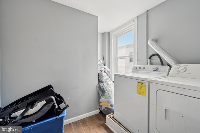 laundry room with dark wood-type flooring and washer and dryer