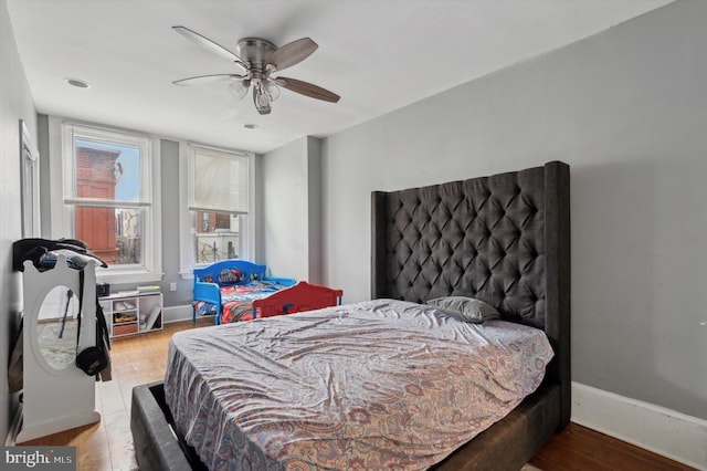 bedroom with light hardwood / wood-style floors and ceiling fan