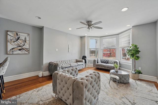 living room with hardwood / wood-style flooring and ceiling fan