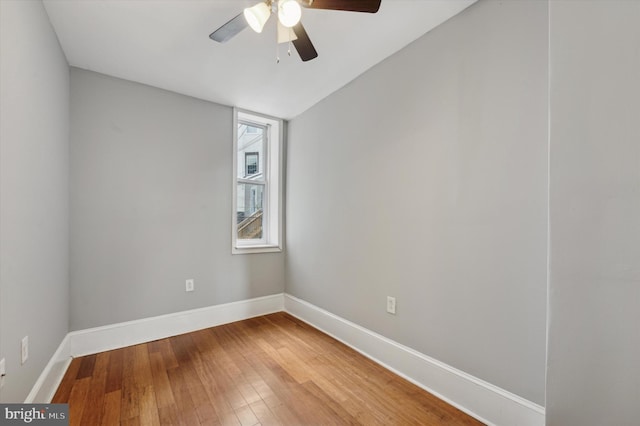 spare room with hardwood / wood-style flooring and ceiling fan