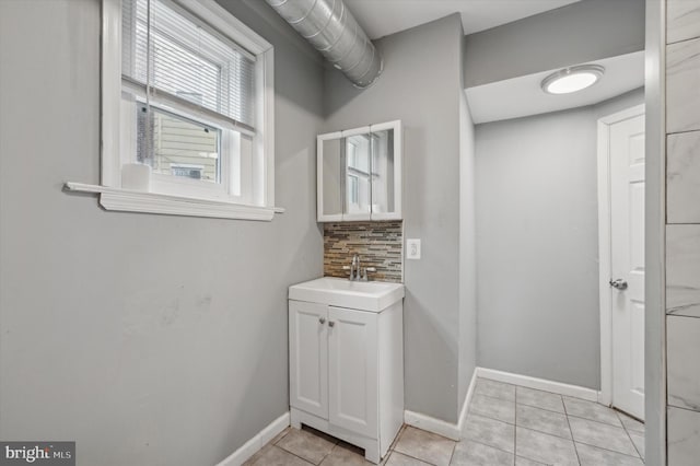 bathroom featuring tasteful backsplash, vanity, and tile patterned floors