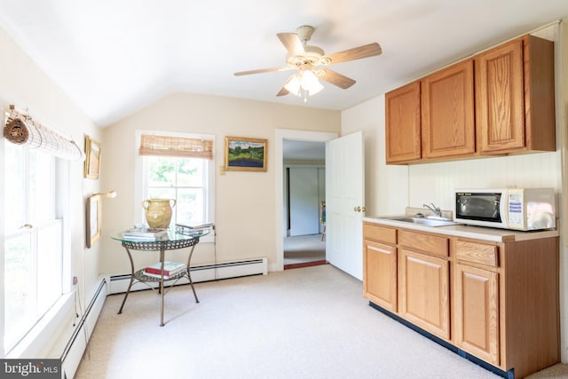 kitchen featuring ceiling fan, light colored carpet, sink, and vaulted ceiling