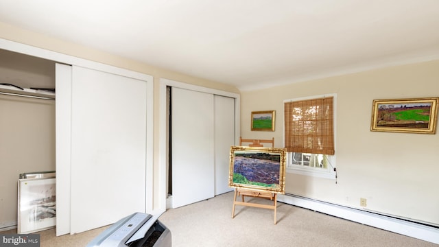 living area featuring a baseboard heating unit and light colored carpet