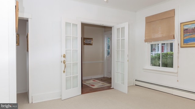 interior space featuring crown molding, a baseboard radiator, and carpet floors