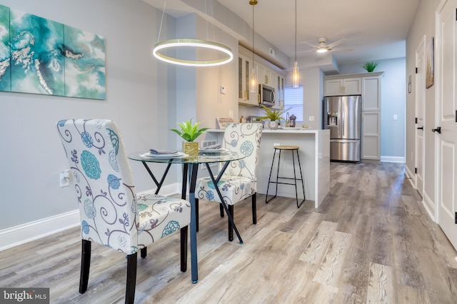 dining space featuring light hardwood / wood-style floors and ceiling fan