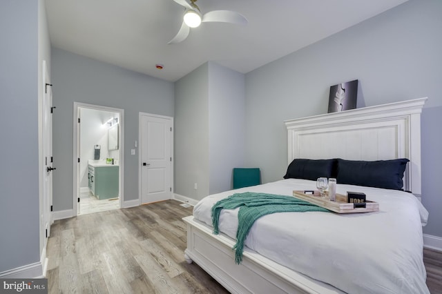 bedroom with connected bathroom, ceiling fan, and light wood-type flooring