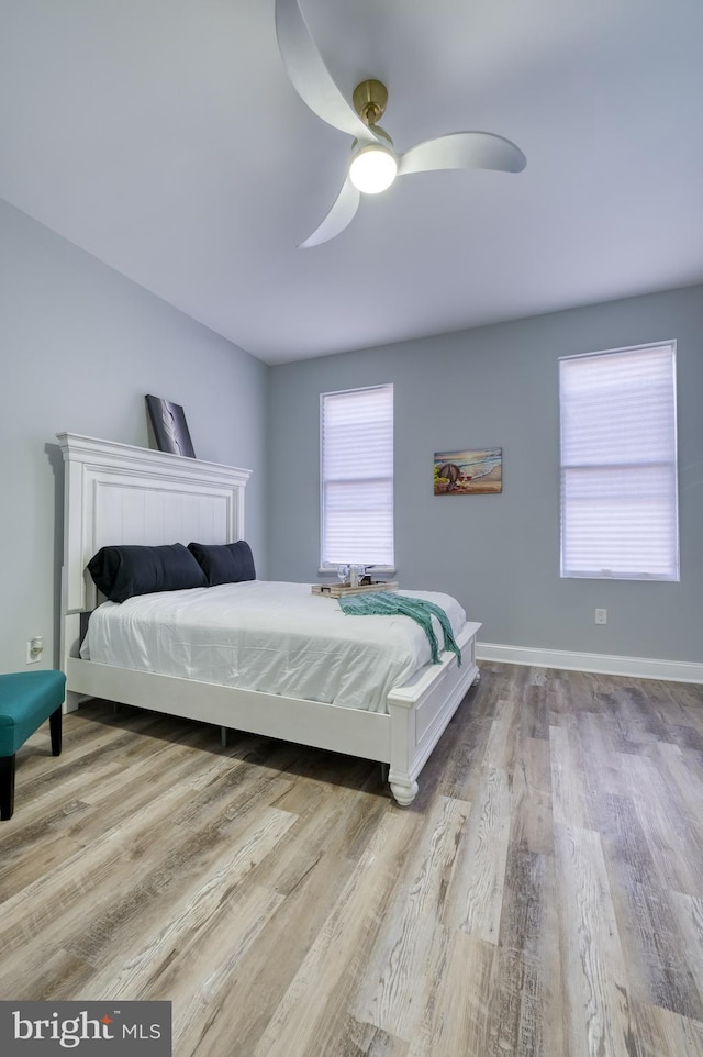 bedroom with ceiling fan and light hardwood / wood-style flooring