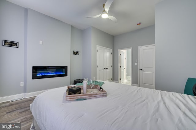 bedroom featuring wood-type flooring and ceiling fan