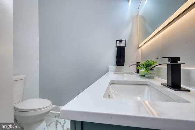 bathroom with vanity and toilet