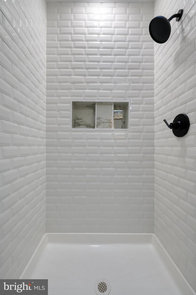 bathroom with a tile shower